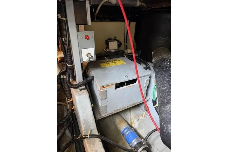 Slide: The Image of Engine compartment of a 1989 Sea Ray 460 Express Cruiser with visible wiring and components. - 31
