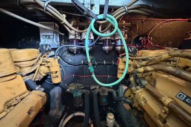Slide: The Image of Engine room of a 1989 Sea Ray 460 Express Cruiser with visible machinery and wiring. - 32
