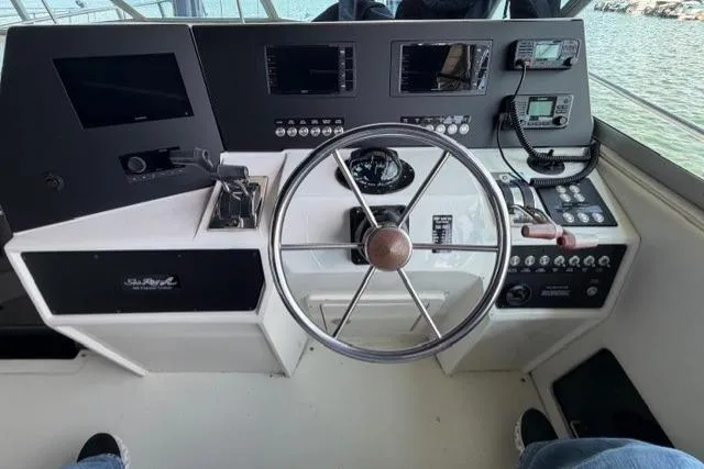 Slide: The Image of Cockpit of 1989 Sea Ray 460 Express Cruiser with steering wheel and control panels. - 5