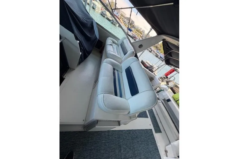 Slide: The Image of 1989 Sea Ray 460 Express Cruiser interior seating with marina view. - 6