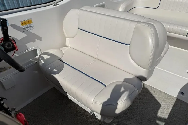 Slide: The Image of White leather seating in a 2000 Chaparral Signature 240 boat interior. - 10