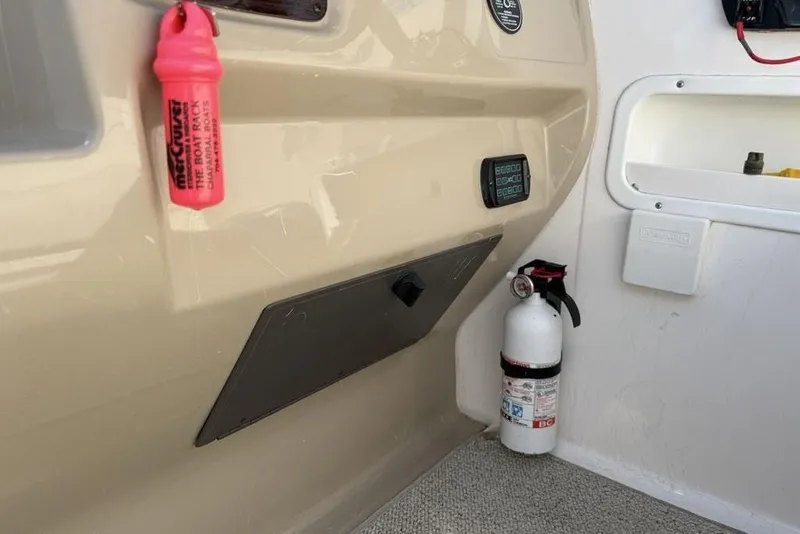 Slide: The Image of Interior of 2000 Chaparral Signature 240 boat with fire extinguisher and safety equipment. - 12
