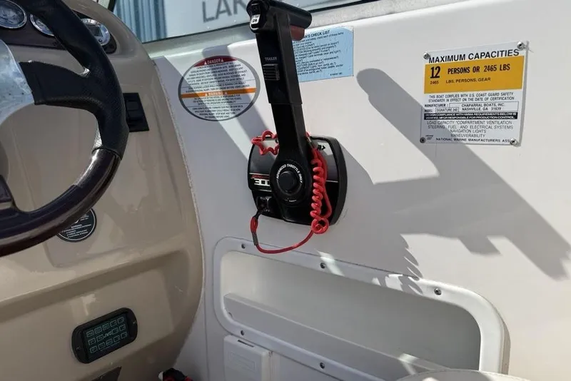 Slide: The Image of 2000 Chaparral Signature 240 boat cockpit with steering wheel and throttle controls. - 13