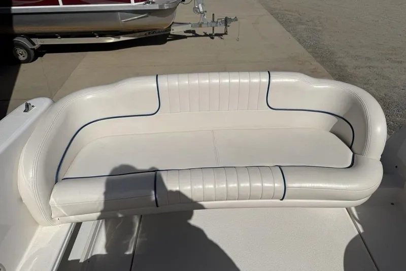 Slide: The Image of White leather seating on a 2000 Chaparral Signature 240 boat, featuring blue accents. - 18