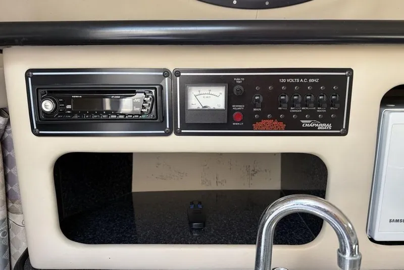 Slide: The Image of Control panel of a 2000 Chaparral Signature 240 boat with stereo and electrical switches. - 22