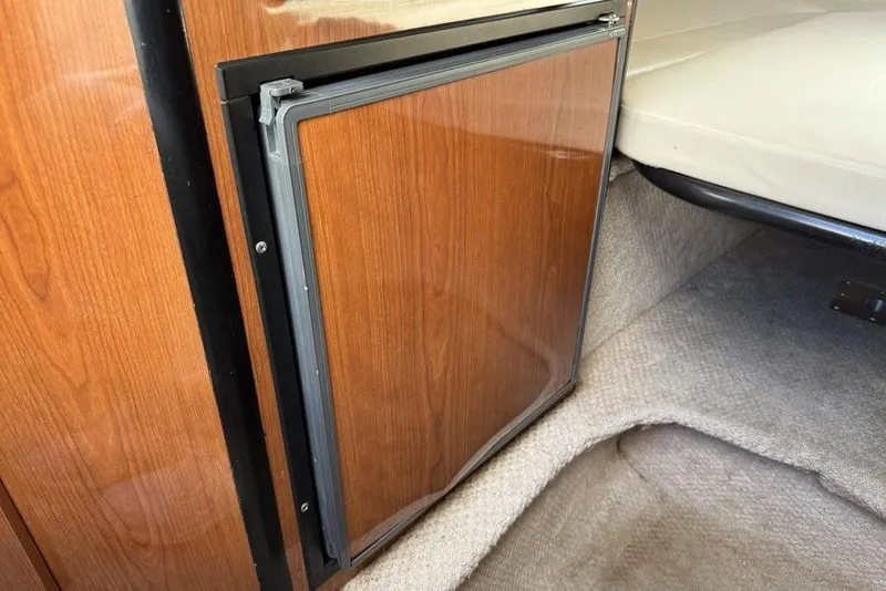 Slide: The Image of Wood-paneled mini fridge in 2000 Chaparral Signature 240 boat interior. - 30