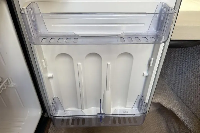 Slide: The Image of Refrigerator door shelves in a 2000 Chaparral Signature 240 boat. - 32