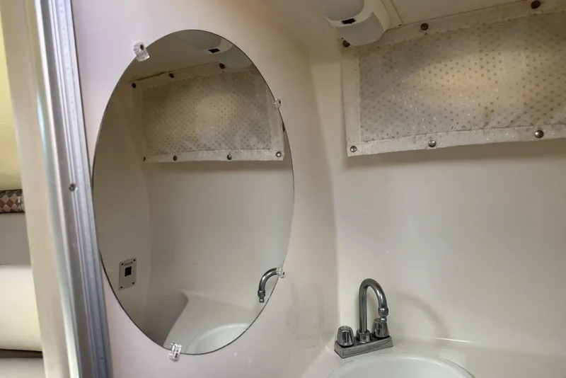 Slide: The Image of Interior of 2000 Chaparral Signature 240 boat bathroom with mirror and sink. - 34