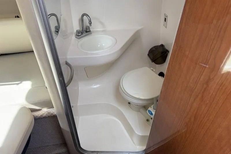 Slide: The Image of 2000 Chaparral Signature 240 boat bathroom with sink and toilet. - 35