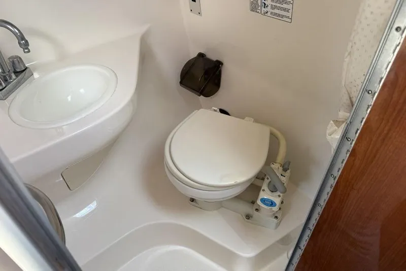 Slide: The Image of Compact bathroom in 2000 Chaparral Signature 240 boat with sink and toilet. - 37
