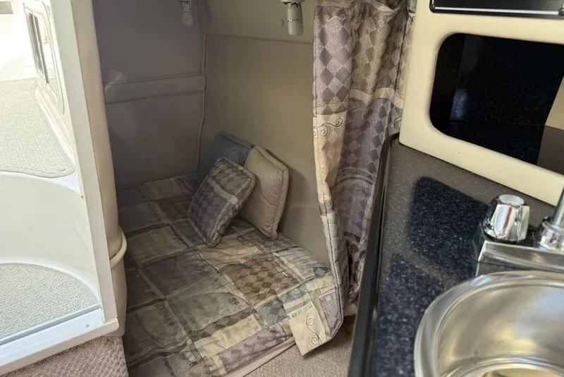 Slide: The Image of Interior cabin of 2000 Chaparral Signature 240 with cozy bedding and compact sink. - 38