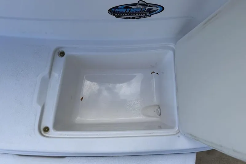 Slide: The Image of Open storage compartment on a 2000 Chaparral Signature 240 boat. - 43