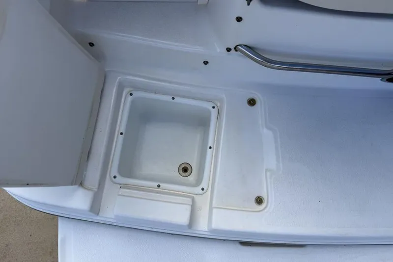 Slide: The Image of 2000 Chaparral Signature 240 boat deck with storage compartment and stainless steel handle. - 45