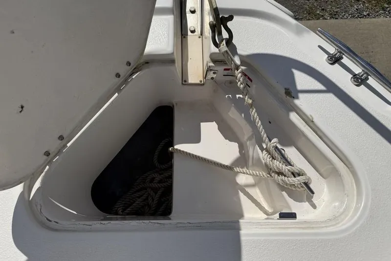 Slide: The Image of Open anchor locker on a 2000 Chaparral Signature 240 boat, showing ropes and cleat. - 5