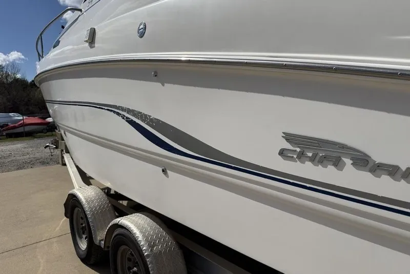 Slide: The Image of 2000 Chaparral Signature 240 boat on trailer, side view with logo visible. - 9