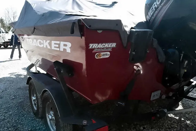 Slide: The Image of 2018 Tracker Targa V-18 Combo boat with cover on trailer, featuring Mercury outboard motor. - 10