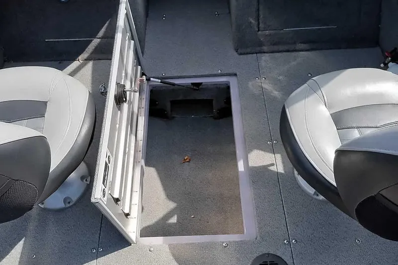 Slide: The Image of 2018 Tracker Targa V-18 Combo boat interior with open storage compartment and seating. - 13