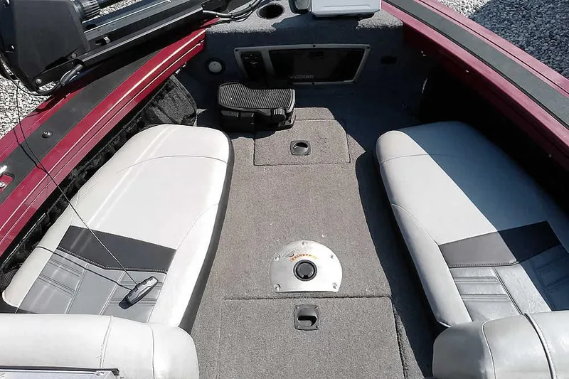 Slide: The Image of 2018 Tracker Targa V-18 Combo boat interior with gray seating and carpeted floor. - 15