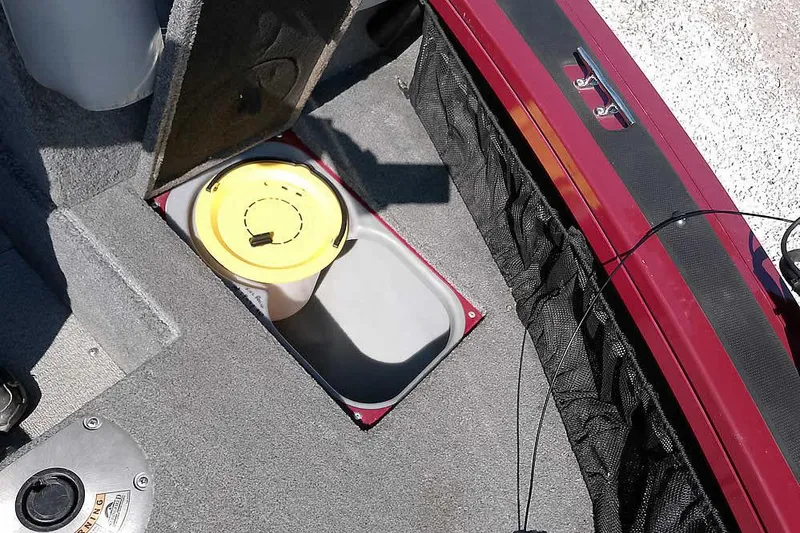 Slide: The Image of 2018 Tracker Targa V-18 Combo boat interior with storage compartment open. - 18