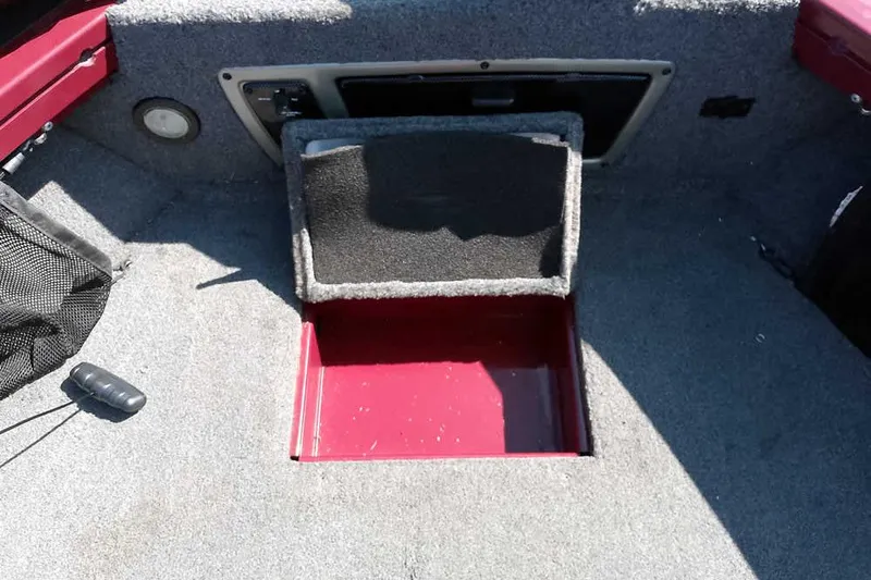 Slide: The Image of 2018 Tracker Targa V-18 Combo boat interior with storage compartment open. - 19