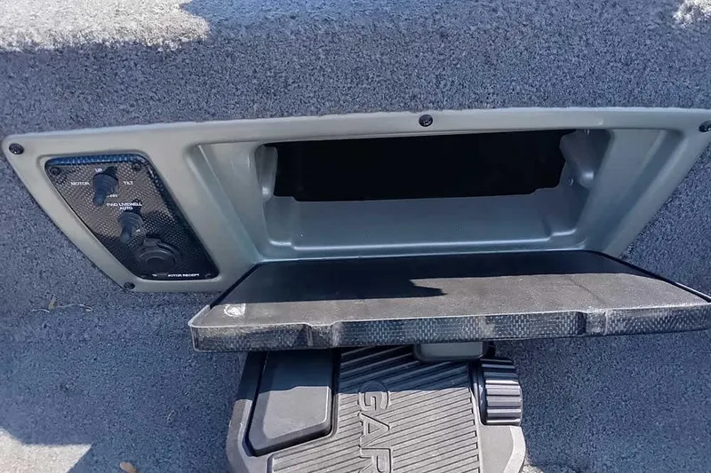 Slide: The Image of Control panel and storage compartment on 2018 Tracker Targa V-18 Combo boat. - 23