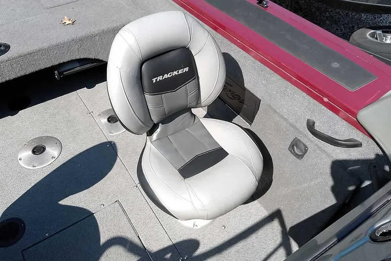 Slide: The Image of 2018 Tracker Targa V-18 Combo boat seat, gray and black upholstery, on deck. - 25