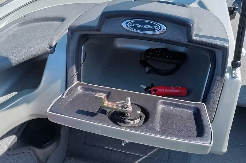 Slide: The Image of 2018 Tracker Targa V-18 Combo boat dashboard storage with accessories and Targa logo. - 27
