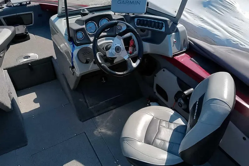 Slide: The Image of Interior of 2018 Tracker Targa V-18 Combo boat with steering wheel and Garmin display. - 30