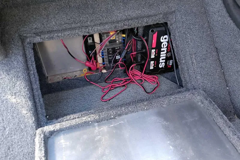 Slide: The Image of 2018 Tracker Targa V-18 Combo boat battery compartment with wiring and Genius charger. - 35