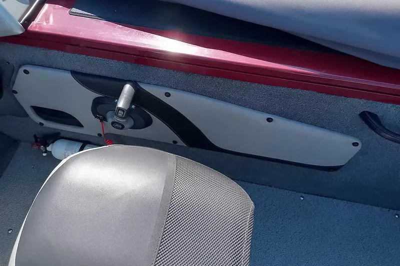 Slide: The Image of Interior of a 2018 Tracker Targa V-18 Combo boat, featuring a control panel and seat. - 37