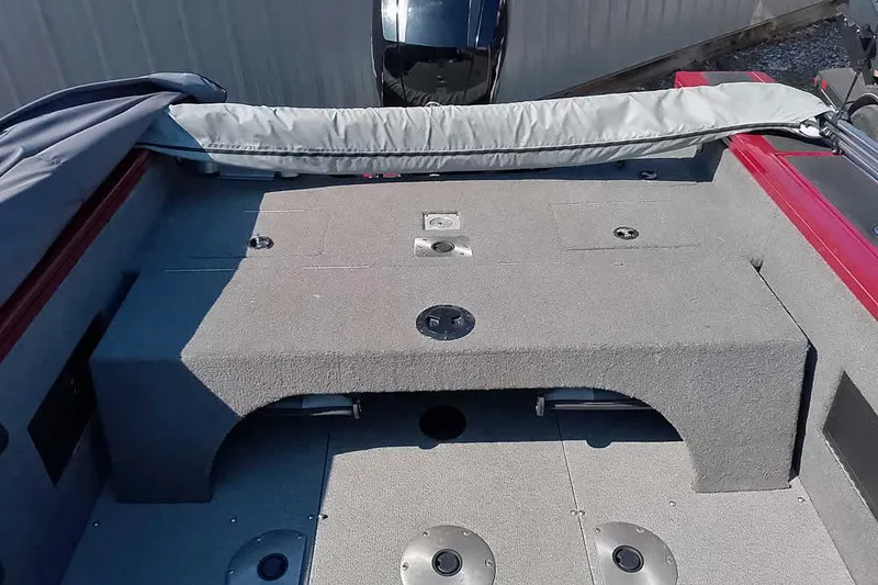 Slide: The Image of 2018 Tracker Targa V-18 Combo boat interior with gray carpeted deck and storage compartments. - 41