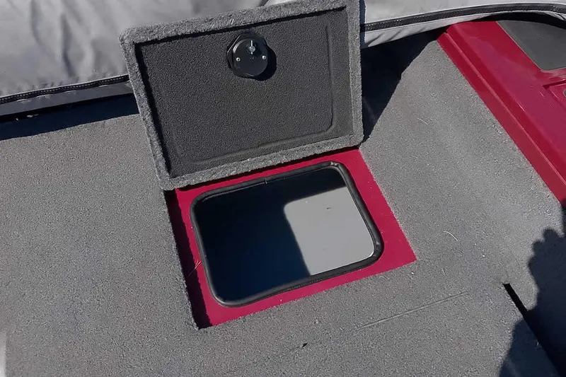 Slide: The Image of Open storage compartment on 2018 Tracker Targa V-18 Combo boat deck. - 42