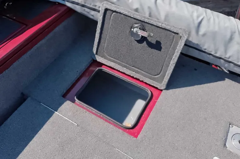 Slide: The Image of Open storage compartment on 2018 Tracker Targa V-18 Combo boat deck. - 43