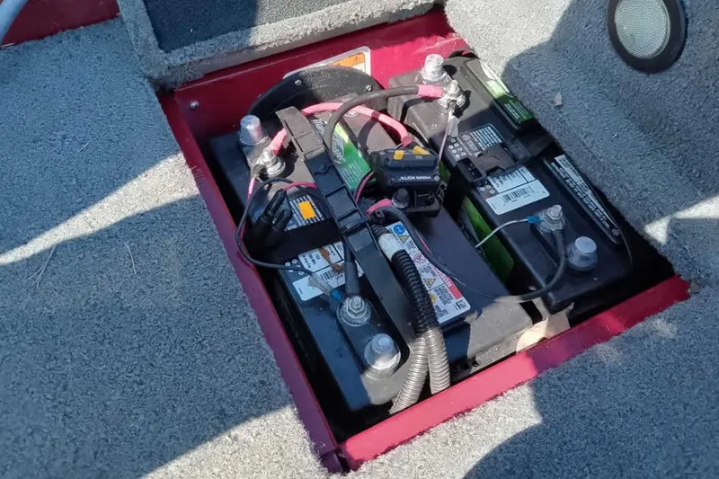 Slide: The Image of Battery compartment of a 2018 Tracker Targa V-18 Combo boat, showing dual batteries. - 47