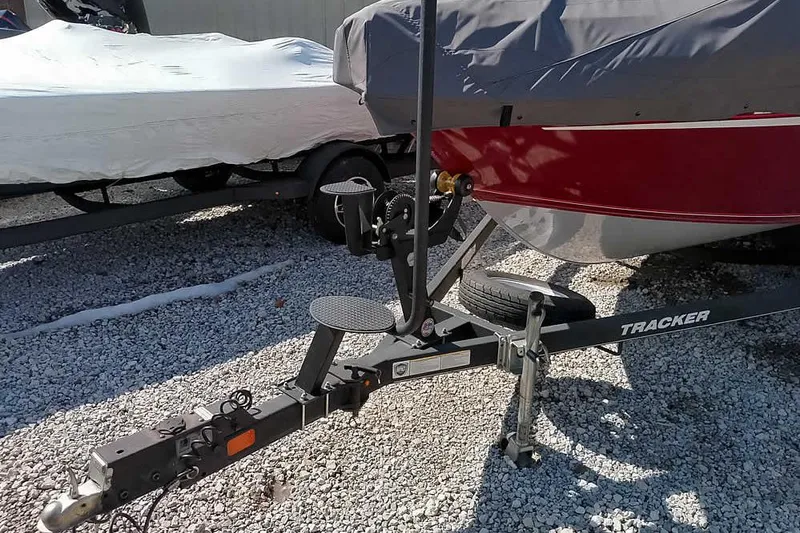 Slide: The Image of 2018 Tracker Targa V-18 Combo boat on trailer, covered and parked on gravel. - 48
