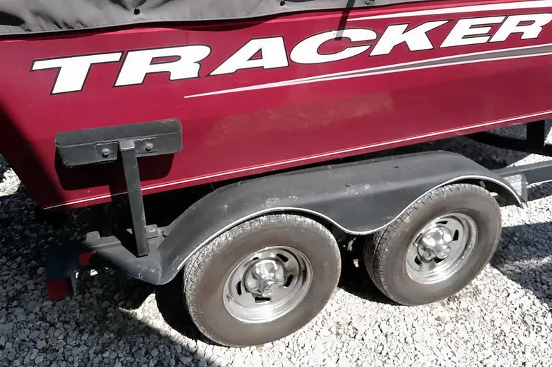 Slide: The Image of 2018 Tracker Targa V-18 Combo boat trailer with dual wheels on gravel. - 7