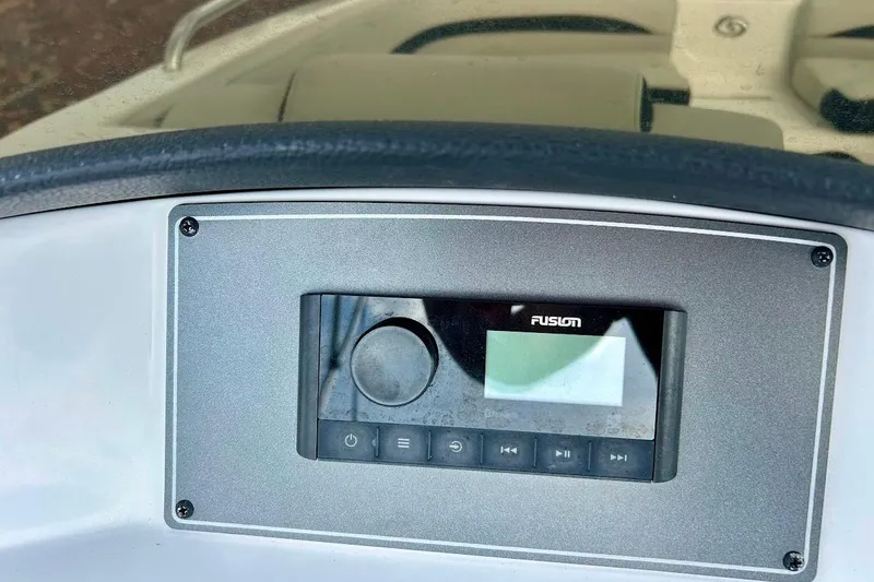 Slide: The Image of 2024 Hurricane Sundeck Sport 218 OB dashboard with Fusion audio system. - 18