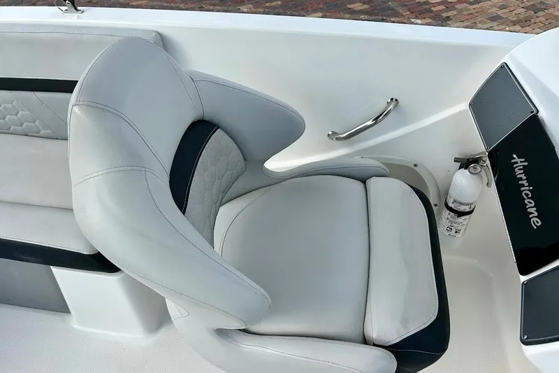 Slide: The Image of 2024 Hurricane Sundeck Sport 218 OB boat interior with cushioned seating and safety equipment. - 20