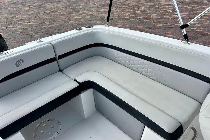Slide: The Image of 2024 Hurricane Sundeck Sport 218 OB boat interior with white cushioned seating and cup holders. - 21