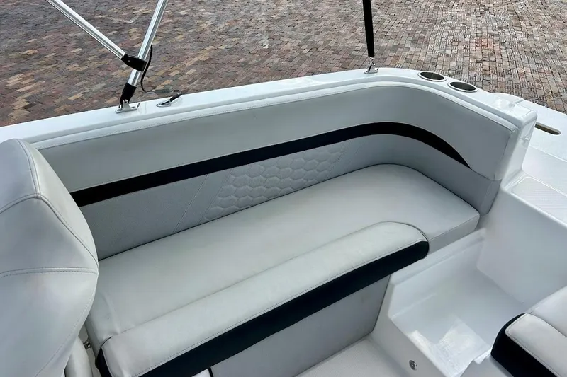 Slide: The Image of 2024 Hurricane Sundeck Sport 218 OB boat interior with cushioned seating and cup holders. - 22