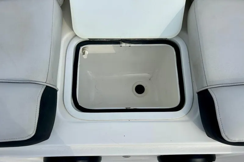 Slide: The Image of 2024 Hurricane Sundeck Sport 218 OB boat storage compartment with cushioned seating. - 26