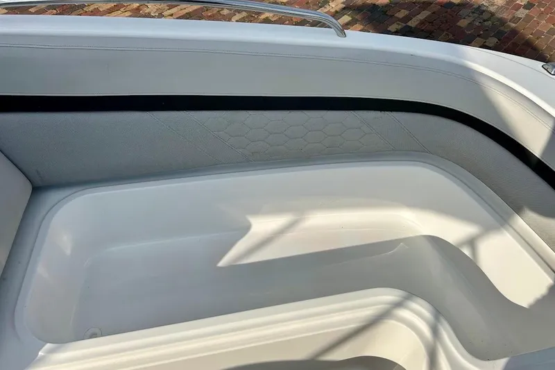 Slide: The Image of 2024 Hurricane Sundeck Sport 218 OB interior seating with sleek white design and hexagonal pattern. - 28