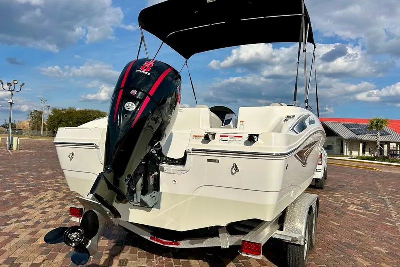 Slide: The Image of 2024 Hurricane Sundeck Sport 218 OB boat with outboard motor on trailer. - 3