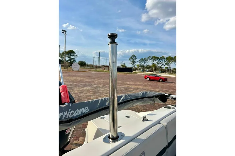 Slide: The Image of 2024 Hurricane Sundeck Sport 218 OB boat detail with clear sky background. - 31