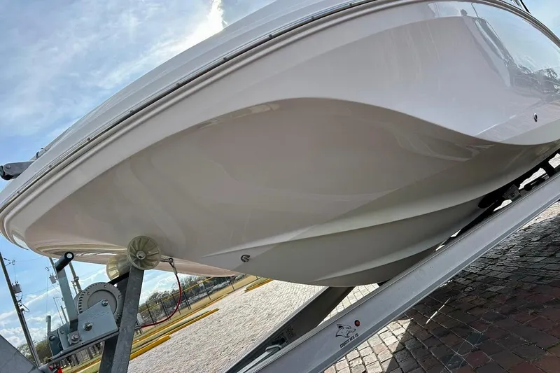 Slide: The Image of 2024 Hurricane Sundeck Sport 218 OB boat on trailer, showcasing sleek hull design. - 6