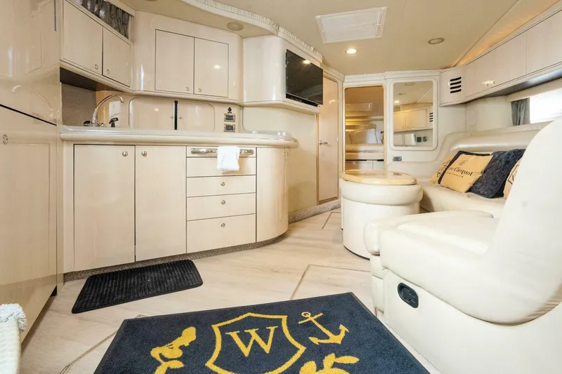 Slide: The Image of Luxurious interior of 2003 Sea Ray Sundancer 460 yacht with modern kitchen and seating area. - 22