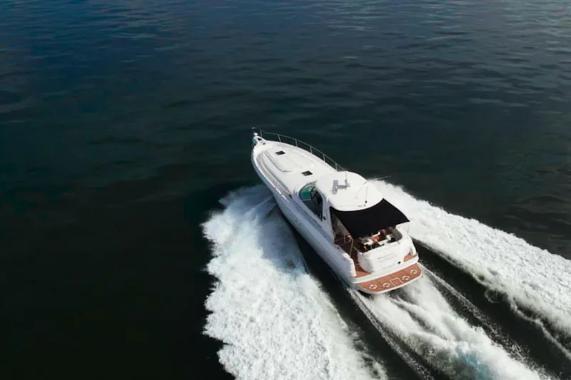 Slide: The Image of Aerial view of 2003 Sea Ray Sundancer 460 yacht cruising on open water. - 3