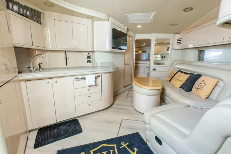 Slide: The Image of Luxurious interior of a 2003 Sea Ray Sundancer 460 yacht with modern kitchen and seating area. - 32