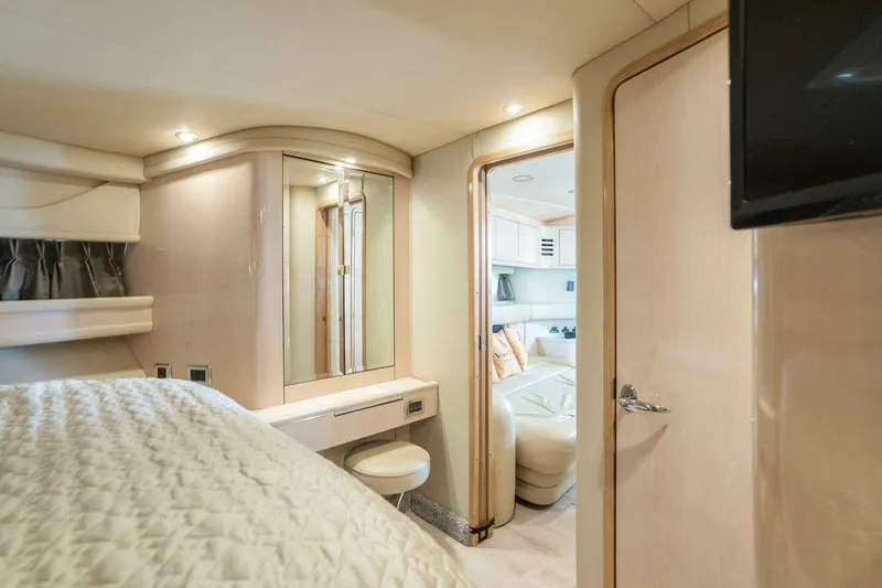 Slide: The Image of Luxurious interior of 2003 Sea Ray Sundancer 460 yacht, featuring elegant bedroom and seating area. - 37