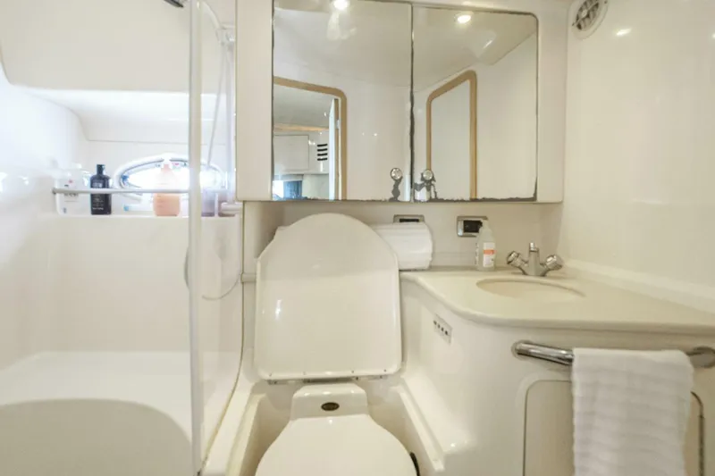 Slide: The Image of Bathroom interior of 2003 Sea Ray Sundancer 460 yacht, featuring toilet, sink, and mirror. - 38